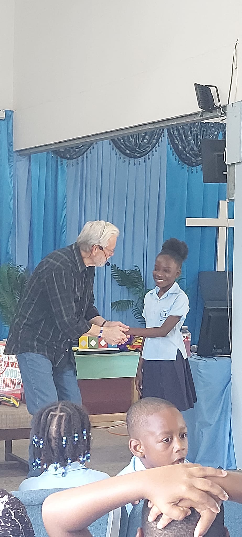 Pastor giving award to a child at special church event